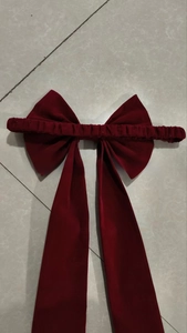 Macro view of a deep red velvet butterfly bow hairband with long flowing ribbons