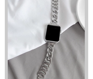 Close-up of silver Cuban link metal strap for Apple Watch with polished finish