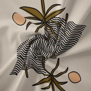 Detail of bohemian tapestry featuring olive green leaves and black wavy stripes on fabric