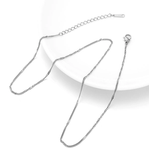 Macro view of silver S925 sterling silver chain with spring clasp and extension tag