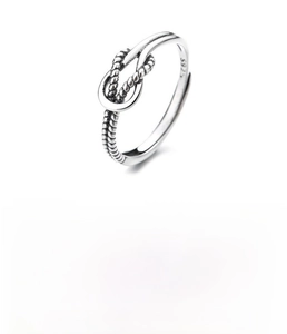 Macro view of S925 sterling silver ring showing the hallmark stamp and twisted rope design