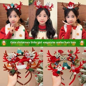 Detail view of festive reindeer antlers and snowflake ornaments on kids Christmas headbands