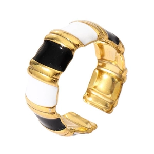 Detail of bamboo texture 18k gold ring with black and white enamel drip oil finish