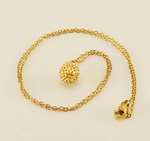 Detail of 18k gold plated stainless steel necklace featuring a spiky durian fruit pendant
