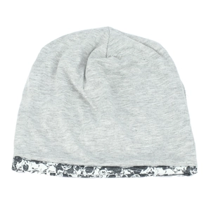 Flat lay view of a light gray beanie featuring an abstract black and white patterned trim