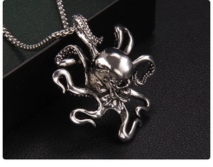Macro shot of silver octopus skull pendant with detailed tentacles and punk metal texture