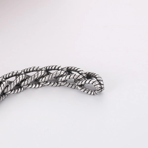 Macro shot of punk style retro braided titanium steel bracelet with antique silver finish