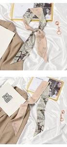 Detail of silk ribbon scarf with horse print and geometric patterns in French retro style