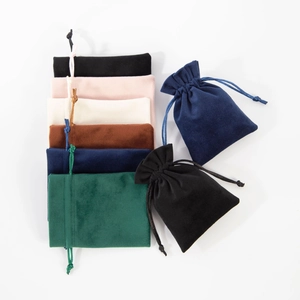 Detailed view of multi-colored velvet drawstring jewelry pouches in various shades