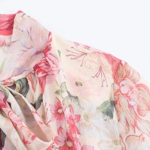 Detail of floral chiffon dress neckline with pink prints and tie-up drawstring design