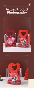 Detail of red PVC gift bag with heart handle featuring a surprise astronaut box