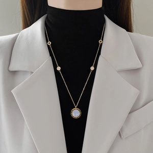 Titanium steel gold necklace with Roman numeral pendant and white pearl inlay on model