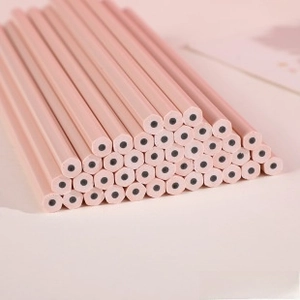 Close-up of pink hexagonal pencils with a matte finish and black lead core in bulk