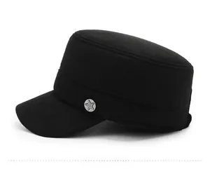 Detail of a black wool flat top military cap featuring a round star metal badge detail