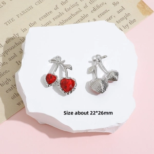 Macro shot of silver cherry pendant with red heart crystals and size detail 22x26mm