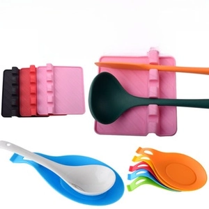Detailed view of heat-resistant silicone spoon rests in multiple colors for clean kitchen counters