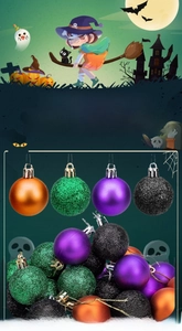 Close-up of Halloween decorative balls with glitter and matte finishes in orange and green