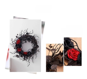 Detail of gothic Halloween wreath featuring black branches and dark red velvet roses