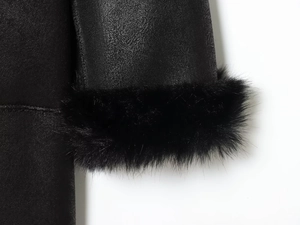 Detailed close-up of the black leather sleeve with plush faux fur trim and fine texture