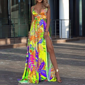 Detail of high-slit tropical floral maxi dress with vibrant yellow and orange leaf prints
