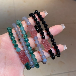 Detail of Pixiu agate and strawberry quartz double-layered beaded bracelets in multiple colors