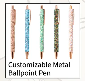 Close-up of glitter metal ballpoint pens in five colors with rose gold accents