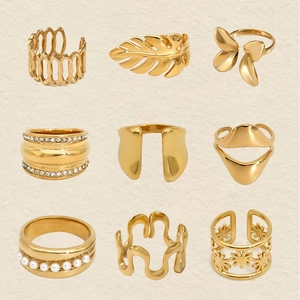 Macro detail of nine-piece gold ring set featuring faux pearls and sparkling crystals