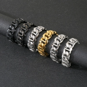 Close-up of cuban link rings in black, gold, and silver finishes with matte textures