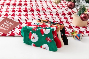 Detailed view of Christmas crew socks with Santa and reindeer motifs in festive colors