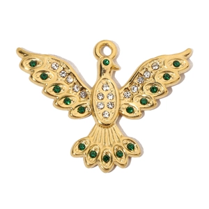 Macro shot of gold bird pendant featuring sparkling clear and green crystal stones