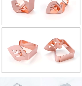 Detailed macro view of leaf-shaped stainless steel tablecloth clips in rose gold and silver
