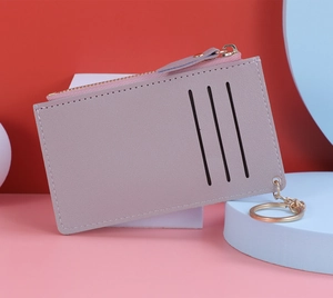 Detail of light purple leather card holder with gold zipper and three card slots