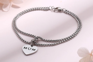 Close-up of double-layer stainless steel chain bracelet with MOM engraved heart charm