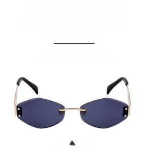 Detail view of rimless sunglasses with dark grey lenses and gold metal temples