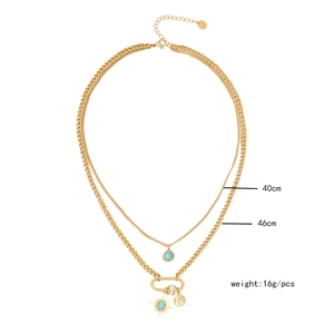 Detail of layered gold necklace with turquoise pendant, sun charm, and size dimensions