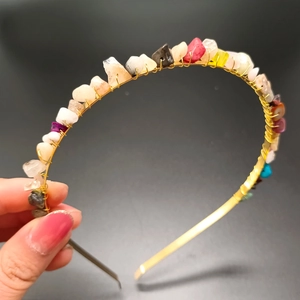 Detail of handmade gold wire headband featuring multicolored natural crystal stones