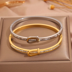 Detail of love engraved bracelets with cubic zirconia stones in gold and silver