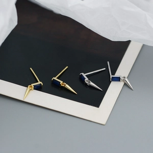 Detailed shot of 925 sterling silver studs with blue zircon and metal spike drops