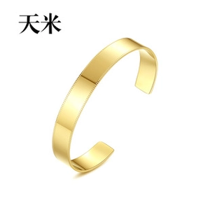 Detail shot of a gold-plated cuff bracelet featuring elegant milgrain beaded edges
