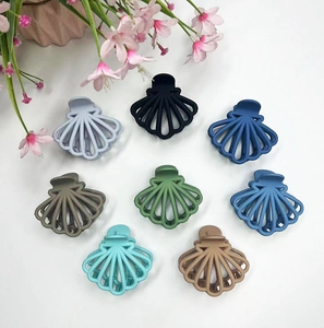 Flat lay of eight hollow fan-shaped hair claws in various matte Morandi colors