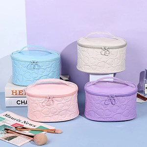 Quilted heart cylinder makeup bags in blue beige pink and purple with top handles