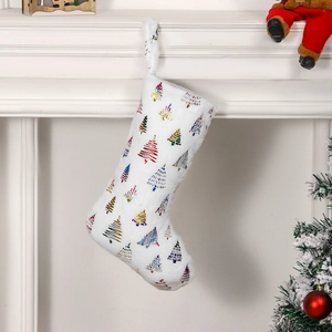White plush Christmas stocking with colorful metallic tree foil prints hanging on fireplace