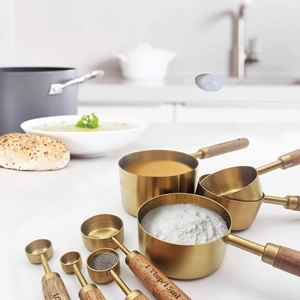 8-piece gold stainless steel measuring cups and spoons set with acacia wood handles