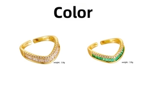 Detailed view of two V-shaped gold rings with white and green zircons weighing 3.0g