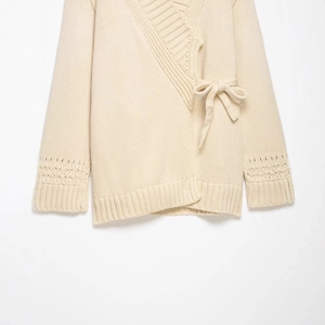 Elegant cream knit wrap cardigan with V-neck, side bow tie and openwork sleeve details