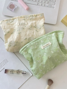 Lace floral cosmetic bags in beige and green colors for skincare and makeup storage