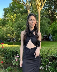 Detail of a black halter dress featuring a 3D rose appliqué and cross cutout neckline