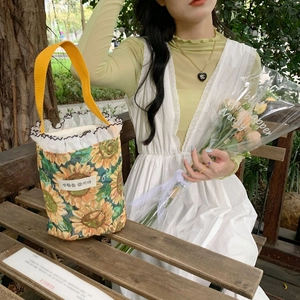 Polka dot mini canvas tote bag with sunflower print, ruffle trim and yellow handles