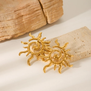 Golden spiral sun stud earrings in stainless steel with hammered texture on stone background