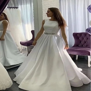 Elegant white sleeveless satin ball gown with a sparkling sequin waist belt for weddings